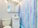 This bathroom features a bathtub with shower curtain, a toilet, a sink and an overhead mirror at 551 Sheridan Dr, Venice, FL 34293