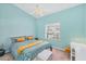 Inviting bedroom with blue walls, cozy bedding, ceiling fan, and natural light at 5744 Sabal Trace Dr # 202Bd5, North Port, FL 34287