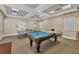 Well-lit game room equipped with a billiard table and ping pong for recreational activities at 5744 Sabal Trace Dr # 202Bd5, North Port, FL 34287