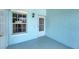 A light blue patio includes a door with a window, concrete flooring, and light-colored walls at 5744 Sabal Trace Dr # 202Bd5, North Port, FL 34287