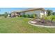 Single-story house with well-maintained lawn, mature landscaping and a concrete curb at 5875 Jackson, Venice, FL 34293