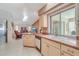 Open kitchen with view to living room, tile floors, lots of counterspace and natural light from a window at 5875 Jackson, Venice, FL 34293