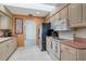 Well-lit kitchen with modern appliances, tile floors, ample counter space and a skylight at 5875 Jackson, Venice, FL 34293
