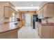 Bright kitchen with stainless steel appliances, tile floors, a skylight and ample counter space at 5875 Jackson, Venice, FL 34293