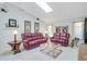 Cozy living room featuring comfortable seating, a skylight and tile flooring at 5875 Jackson, Venice, FL 34293