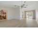 An open concept living room with vaulted ceilings, light wood-look flooring, and sliding doors to the lanai at 5875 Jackson, Venice, FL 34293