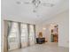 Bright living room features vaulted ceilings, a ceiling fan, and light-colored, wood-look floors at 5875 Jackson, Venice, FL 34293