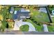 Aerial view of a home with a circular driveway, ample yard, and a shed in the back at 605 Cumberland Rd, Venice, FL 34293