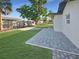 Beautiful backyard featuring lush green grass and a paved patio area at 605 Cumberland Rd, Venice, FL 34293