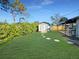 The backyard is well-kept, featuring manicured grass and a storage shed at 605 Cumberland Rd, Venice, FL 34293