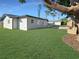 Well-manicured backyard featuring lush green grass and a storage shed at 605 Cumberland Rd, Venice, FL 34293