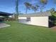 Well-maintained backyard with a shed featuring gray trim and a window, providing extra storage space at 605 Cumberland Rd, Venice, FL 34293