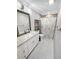 Bright bathroom features granite counters, white cabinets, and decorative shower curtain at 605 Cumberland Rd, Venice, FL 34293