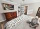 Comfortable bedroom with hardwood floors, complemented by stylish decor, including a dresser and television at 605 Cumberland Rd, Venice, FL 34293