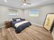 Simple and elegant bedroom design with a large bed, wood floors, and ambient natural light at 605 Cumberland Rd, Venice, FL 34293