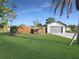 Inviting single-Gathering home featuring a two-car garage, lush green lawn, and a classic wooden privacy fence at 605 Cumberland Rd, Venice, FL 34293