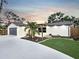 Charming single-story home featuring a well-maintained lawn, palm trees and modern design at 605 Cumberland Rd, Venice, FL 34293