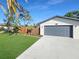 A close-up view of the home's facade highlights the two-car garage and freshly painted exterior at 605 Cumberland Rd, Venice, FL 34293