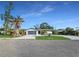 Charming single-story home with mature landscaping, circular driveway, and lush green lawn at 605 Cumberland Rd, Venice, FL 34293