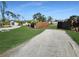 Lush lawn and manicured landscaping frame this charming home, complemented by a classic wooden fence at 605 Cumberland Rd, Venice, FL 34293