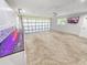 Clean garage featuring custom cabinets, epoxy floors, and transparent garage door at 605 Cumberland Rd, Venice, FL 34293
