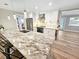Modern kitchen with stainless steel appliances, beautiful granite counters, and stylish pendant lighting at 605 Cumberland Rd, Venice, FL 34293