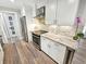 Modern kitchen with stainless steel appliances, white cabinets, and granite countertops at 605 Cumberland Rd, Venice, FL 34293