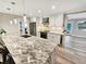 Modern kitchen with stainless steel appliances, beautiful granite counters, and stylish pendant lighting at 605 Cumberland Rd, Venice, FL 34293