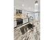Modern kitchen with stainless steel appliances, stylish backsplash, and a granite island sink at 605 Cumberland Rd, Venice, FL 34293
