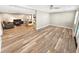 Open-concept living area with wood-look flooring and modern ceiling fan at 605 Cumberland Rd, Venice, FL 34293