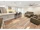 Inviting living room featuring sleek floors, a modern fan, and an open concept to kitchen at 605 Cumberland Rd, Venice, FL 34293