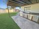 Outdoor kitchen with stainless steel grill and sink under a covered patio, perfect for entertaining at 605 Cumberland Rd, Venice, FL 34293
