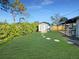 Backyard shed with a small patio and stepping stones through the backyard at 605 Cumberland Rd, Venice, FL 34293