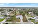 Overhead view of a single-Gathering home with a large yard and driveway in a leafy neighborhood at 6231 Pecan Rd, Venice, FL 34293