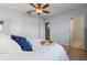 Bright bedroom featuring a white comforter with light-colored wood-look floors and neutral walls and trim at 6458 Baytown Dr, Sarasota, FL 34240