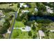 Aerial view of neighborhood homes, ponds and lush landscaping in a sunny, residential location at 651 Percheron Cir, Nokomis, FL 34275