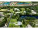 Wide aerial view of a neighborhood with homes, ponds, and lush landscaping in a residential setting at 651 Percheron Cir, Nokomis, FL 34275