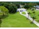 Aerial view of house showing an expansive front yard and a circular driveway with mature landscaping at 651 Percheron Cir, Nokomis, FL 34275