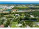 Aerial view showing a neighborhood with homes, ponds, trees and landscaping near the ocean at 651 Percheron Cir, Nokomis, FL 34275