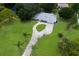 Expansive property featuring a circular driveway, lush green lawn and mature trees from above at 651 Percheron Cir, Nokomis, FL 34275