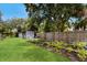Spacious backyard with a garden and shed, perfect for outdoor activities and storage at 651 Percheron Cir, Nokomis, FL 34275