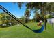 Backyard oasis featuring a hammock, a pond and mature shade trees for relaxation and enjoyment at 651 Percheron Cir, Nokomis, FL 34275