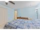 Cozy bedroom featuring tile floors, blue walls, and ceiling fan at 651 Percheron Cir, Nokomis, FL 34275