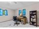 Bedroom with tile floor, ceiling fan, desk, and a built in bookshelf at 651 Percheron Cir, Nokomis, FL 34275