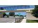 Bike route overpass on Legacy Trail, featuring signage and safety fencing over a sunny street at 651 Percheron Cir, Nokomis, FL 34275