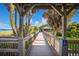 Elevated boardwalk with scenic views, connecting the beach, greenery, and nearby picnic area at 651 Percheron Cir, Nokomis, FL 34275