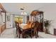 Elegant dining room with decorative china cabinet, ornate table and chairs, and natural light at 651 Percheron Cir, Nokomis, FL 34275