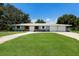 Charming single-story home featuring a stone accent, a well-manicured lawn, and an extra wide driveway at 651 Percheron Cir, Nokomis, FL 34275