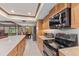 Open kitchen featuring stainless steel appliances and a breakfast bar at 651 Percheron Cir, Nokomis, FL 34275