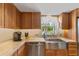 Kitchen featuring stainless steel appliances, a farmhouse sink, and plenty of counter space at 651 Percheron Cir, Nokomis, FL 34275
